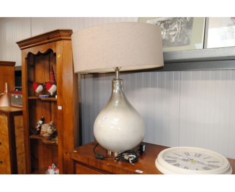 A mercury glass effect table lamp and shade