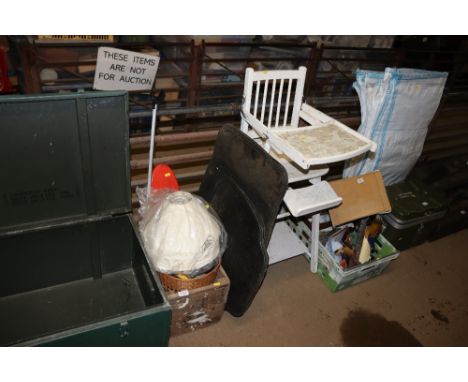 A box containing a battery charger, pump, skateboard, lampshades, floormats and a vintage highchair