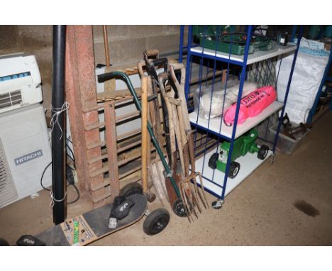 A bundle of long handled gardening tools