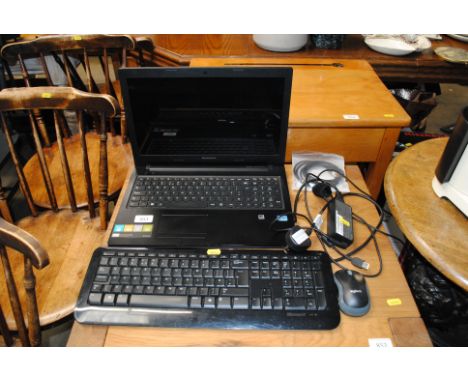 A Lenovo laptop with keyboard and mouse