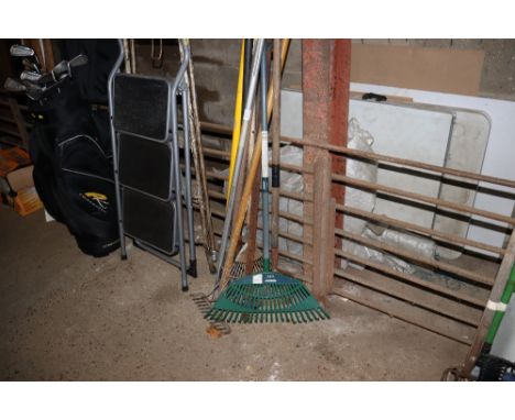 A bundle of long handled gardening tools
