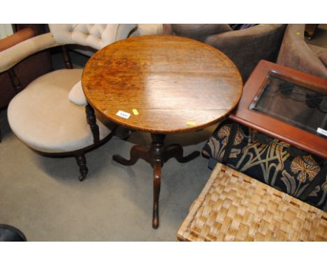 An oak laptop table raised on tripod base