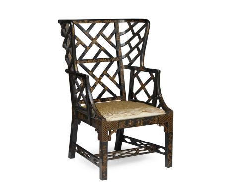  EDWARDIAN BLACK LACQUER LATTICE BACK WING ARMCHAIR EARLY 20TH CENTURY in the Chinese Chippendale taste, with an open fretwor