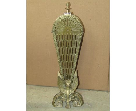 A brass fan shaped firescreen with retractable framework