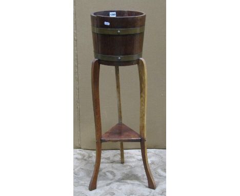 An R A Lister &amp; Co Ltd coopered oak and banded jardiniere and fixed stand 