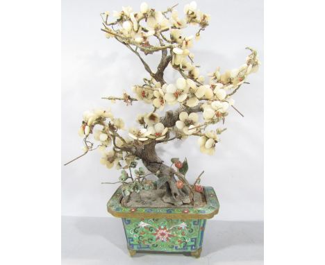 A Chinese hard stone and glass blossom tree set in a cloisonné planter.