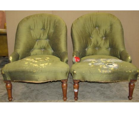 A pair of Victorian style low spoon and button back upholstered drawing room/bedroom chairs raised on turned tapered forelegs