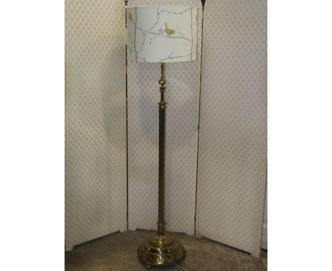 A telescopic cast brass effect standard lamp with reeded column and stepped circular domed base with geometric detail 