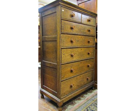Upright oak chest of five long and two short drawers, with turned bobbin split spindle mouldings, on turned supports, 100cm w
