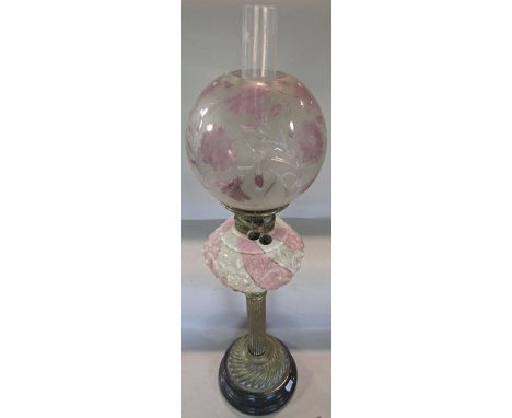 A 19th century Veritas oil lamp, brass reeded column supporting a pink and white striped font and a pink floral shade which b