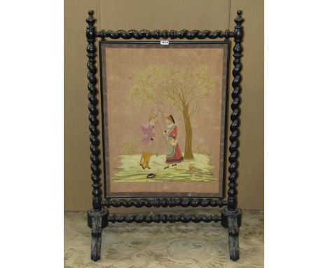 19th century firescreen, the ebonised frame with barley twist supports, enclosing a hand worked panel showing an orchard scen