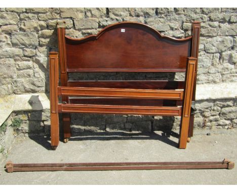 An Edwardian mahogany four foot bedstead with carved and moulded detail, together with a further similar but plainer example,