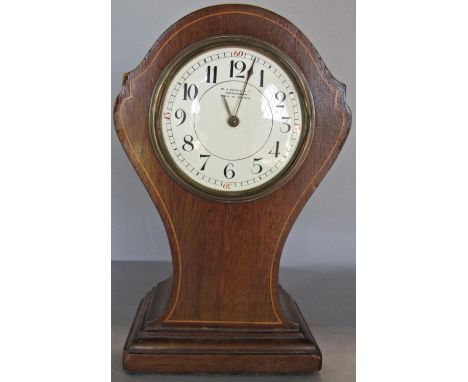 An inlaid Edwardian mantle clock with shaped outline, enamel dial and eight day timepiece 