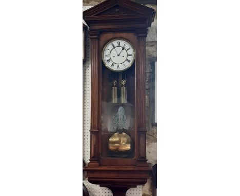 A Lenzkrich Vienna style wall clock, the oak case with reeded column supports and architectural pediment, the glass front enc