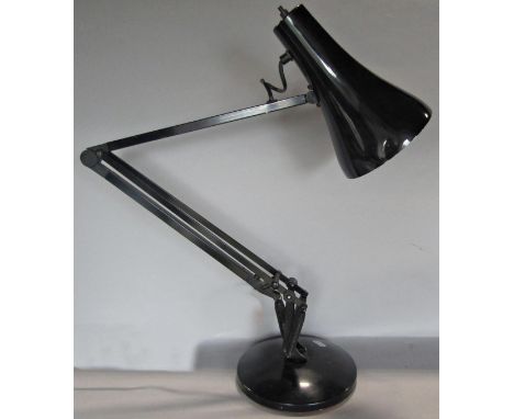 A black enamel anglepoise lamp on a circular base