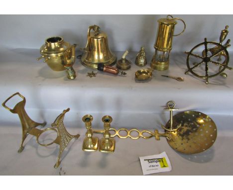 A collection of brass ware including a brass bell, miners lamp, andirons, horse brasses, trivet stand, kettle etc 