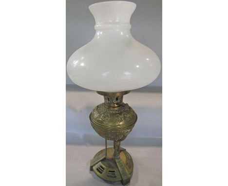 A 19th century brass oil lamp with engraved font, with an opaque white shade, lacks chimney. 