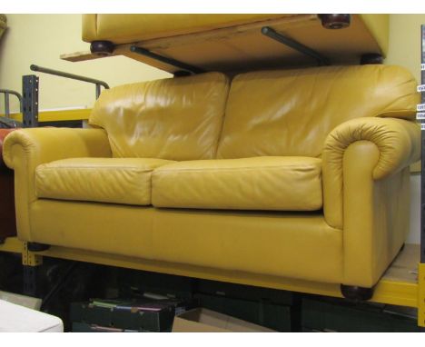 A Saxon three seater sofa in mustard coloured leather fabric, with scrolled arms raised on bun feet, 190cm wide