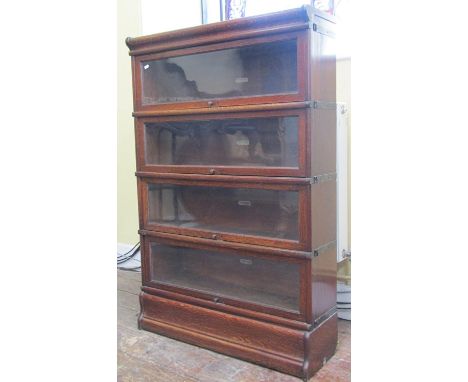 A Globe Wernicke four tier oak bookcase with glazed up and over doors 