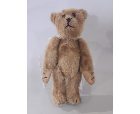 Small pre war teddy bear with boot button eyes, stitched mouth, nose and claws and jointed body. Height 21cm, with doll/ tedd