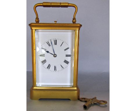 A 19th century English carriage clock with eight day striking movement and repeat action, with original casework 