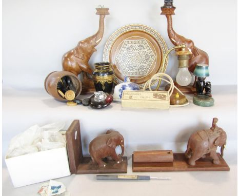 A box of items including a pair of wooden elephant table lamps, a Damascus style inlaid wooden tray, a novelty black cat and 