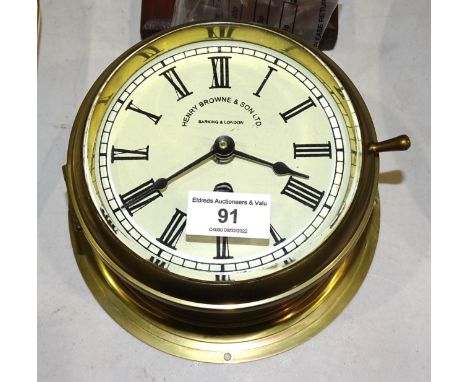 A Sestrel brass bulkhead ships clock, the dial marked Henry Browne &amp; Son Ltd, Barking &amp; London, 18cm diameter, a repr