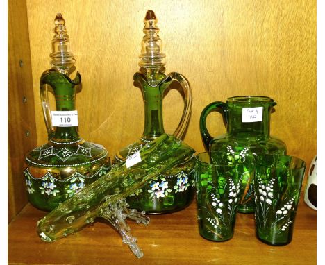 A pair of late-19th century green glass decanters with coloured enamel floral decoration and clear glass stoppers, (chip to t