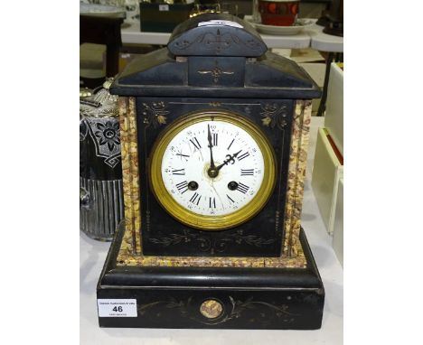 A Victorian black slate mantel clock of architectural form, with bell-striking movement, stamped GR, 30cm high. 