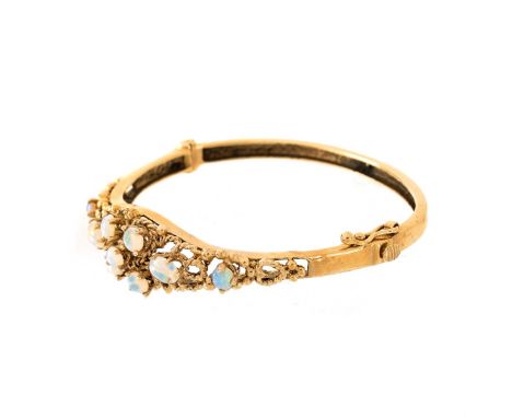 Vintage Oval Cabochon Opal and 14 Karat Yellow Gold Cuff Bangle Bracelet. Stamped 14K. Measures 1/2" W, 2" interior diameter.