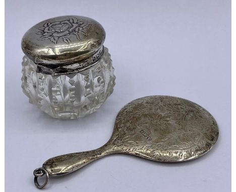 A small silver backed hand mirror and dressing table pot with hallmarked silver top.