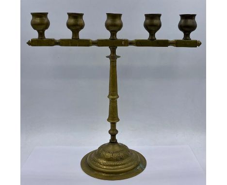 A Five light Iranian brass candlestick
