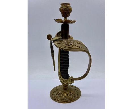 A Royal Navy sword hilt, converted to a candlestick.