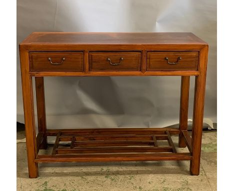 An oriental style hard wood console table with three drawers to centre and shelf (H80cm W100cm D36CM)