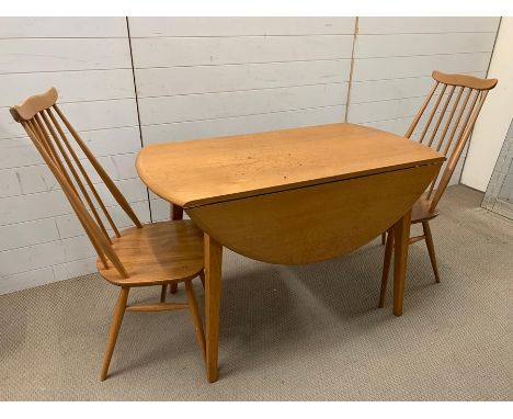 An Ercol dining table and No 369 Goldsmith chairs 