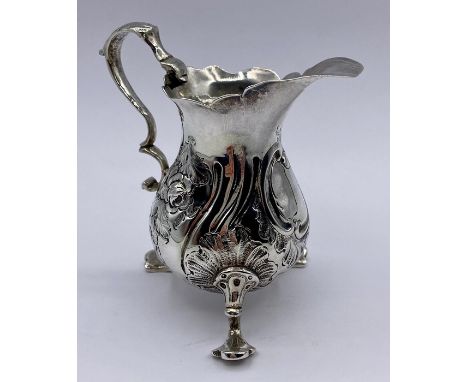 A Georgian silver milk jug with indistinct hallmarks. 