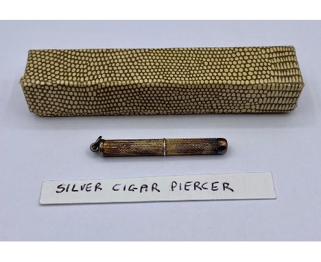 A silver cigar piercer
