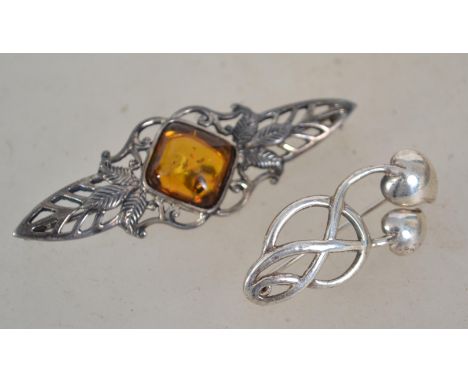 A sterling silver 925 Art Nouveau style brooch having leaf design with central amber cabochon with rollover catch along with 