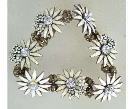 A fantastic Danish bracelet having large white enamel flowers with central clear stones by Pilgrim. Weighs 49.3 grams and mea