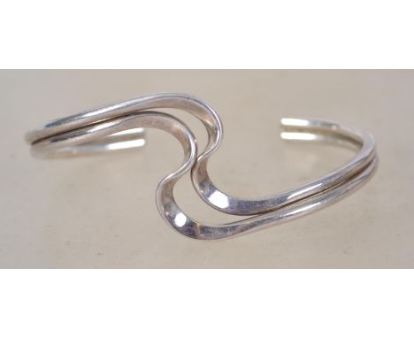 A sterling silver 925 twin bar bangle bracelet of crossover form. Weighs 22.9 grams and measures 7cms wide.