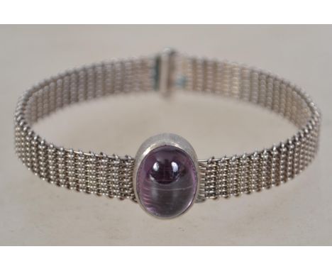 A vintage silver and amethyst woven wire bangle bracelet. Unmarked but tests as silver. Measures 6.5cms and weighs 22.1 grams