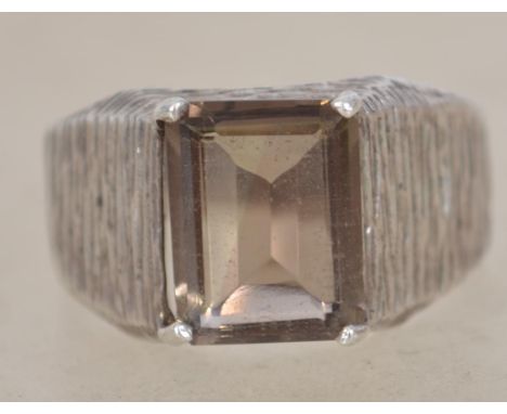 A sterling silver 925 modernist Brutalist ring having naturalistic bark effect shoulders with a central smokey quartz stone. 