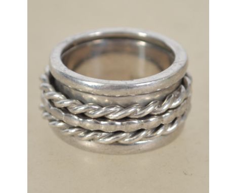 A sterling silver 925 metamorphic band ring of unusual form having three smaller bands to centre. Weighs 14.5 grams size P.