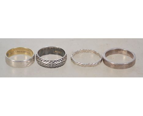 A group of 5 sterling silver rings, 4 being band rings along with a heart shaped signet ring. Total weight 11.8 grams.