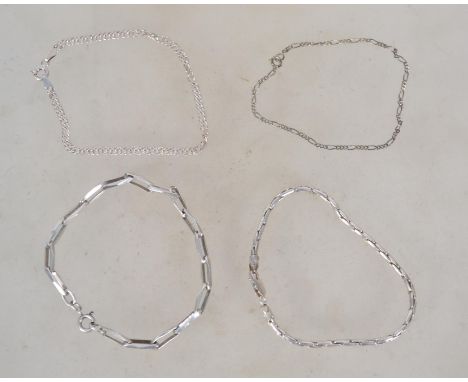 A group of sterling silver 925 bracelets one of rigid link form having a lobster claw clasp, one being a box link chain with 