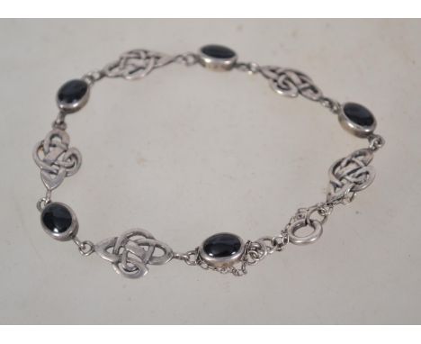 A sterling silver 925 bracelet chain having a Celtic knot design and onyx cabochon spacers having a bolt ring place.&nbsp;