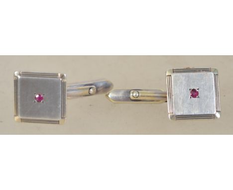 A pair of sterling silver 925 gentleman's cuff links of square form having central garnet stones. Weighs 9.1 grams.&nbsp;