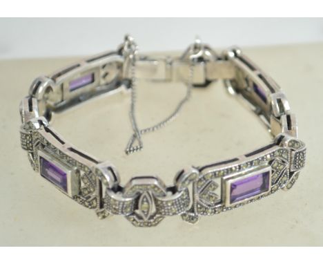 A fantastic sterling silver 925 marcasite panel bracelet having emerald cut amethyst cabochons and safety chain. Measures 7 i