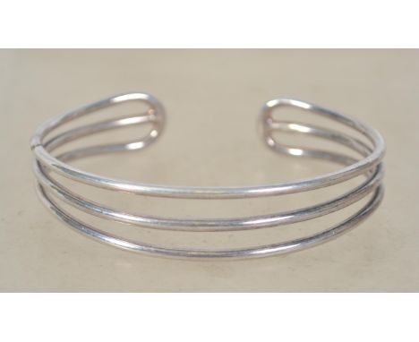 A sterling silver 925 three bar bangle bracelet. Weighs 23.5 grams and measures 7cms wide.