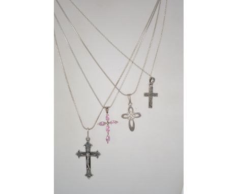 A group of 4 sterling silver 925 necklace chains each having a crucifix drop pendant of varying form. Total weight 19.7 grams